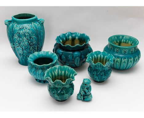 A group of Bretby art pottery turquoise glazed bowls, planters a vase and a decorative monkey figure. Largest 24 cm tall. (7)