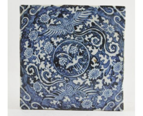 A 19th Century Chinese blue and white square tile, a central roundel framed by scrollwork, 19.5cm square, 3cm thick&nbsp;