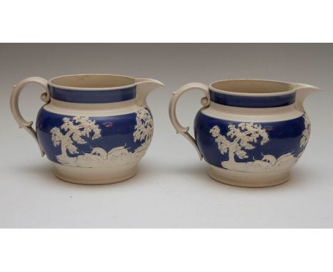 Two large Chetham and Woolley feldspathic stoneware mist-type jugs, circa 1810. Each is decorated with the same hunting scene