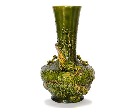 A Bretby art pottery green glazed vase with a well-modelled dragon wrapping around its circumference. No 445. 40 cm tall. (1)