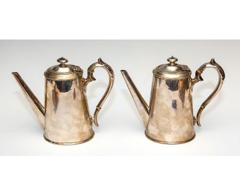 A pair of 19th Century silver plated coffee pots, of oval tapered form, finials, scroll handles, engraved monograms (2)