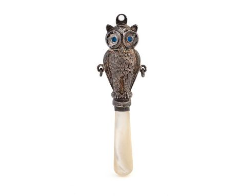 A George V novelty silver baby's rattle handle in the form of an owl, blue glass eyes, mother of pearl handle, maker's mark r