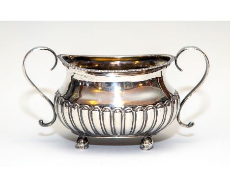A George III silver stop-fluted bombe twin handled sugar basin, maker Soloman Hougham, London 1810, (later inscription), appr