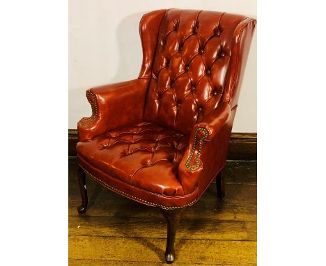 A Chippendale style Chesterfield wingback armchair, circa 1920, button back and seat with scrolled arms inlaid brass stud, ra