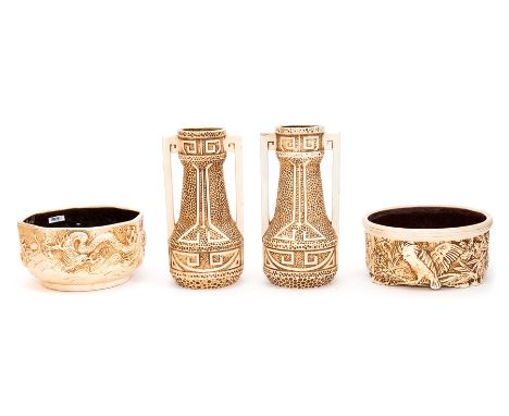 A pair of Bretby Art Pottery moulded ivory ground vases and two similarly moulded and decorated planters. Vases 26 cm tall, P