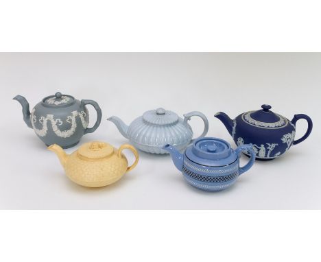A group of nineteenth century teapots and covers, circa 1870-90. Included: A Wedgwood yellow ware basket weave and wheat shea