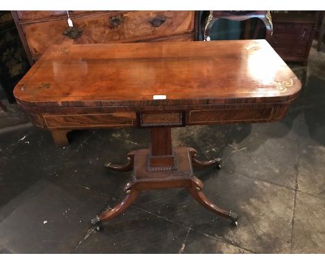 A George IV mahogany and brass inlaid card table, circa 1825,rounded rectangular folding top enclosing inlaid card playing su