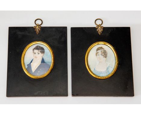 A pair of oval portrait miniatures on ivory, circa 1830, young gentleman wearing a blue tunic and lady companion wearing a bl