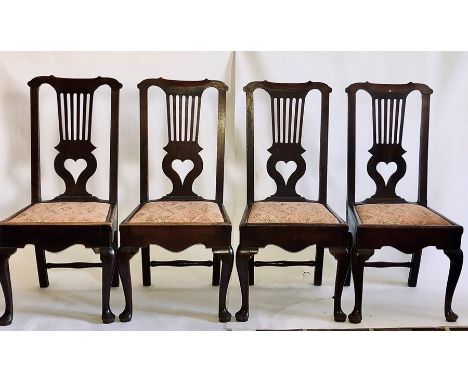 A set of four George III oak dining chairs, circa 1780, Chippendale form with a serpentine arch crest rail centering straight