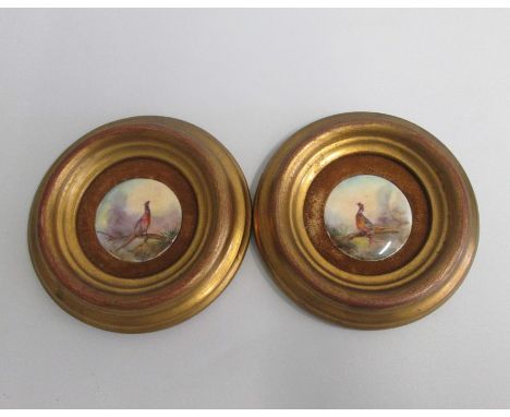 A pair of Royal Worcester Miniature Plaques, painted with Pheasants Signed Jas Stinton.Mounted in wooden gilded framesDate: c