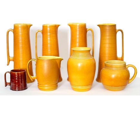 A set of four Bretby Art Pottery tapered tall beer jugs in the Art Deco manner along with similarly decorated tankard, vases 