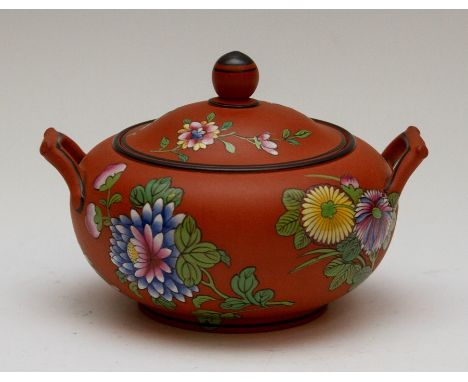 A Wedgwood Rosso Antico lidded sucrier, circa 1810-20. It is decorated with floral motifs including lotus with gilded highlig