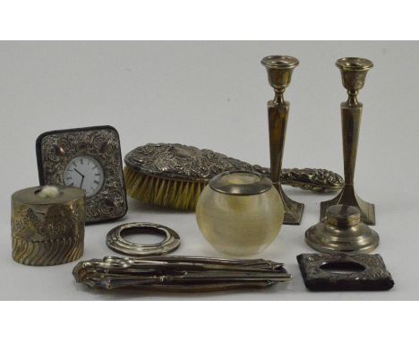 A collection of assorted silverware, including a pair of candlesticks, Birmingham 1914, an embossed brush, an embossed desk c
