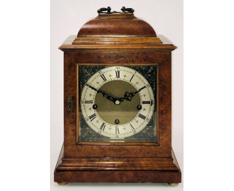 An early 19th Century figured walnut 8-day mantel clock, brass handles and keyhole, square brass dial and spandrel mounts wit