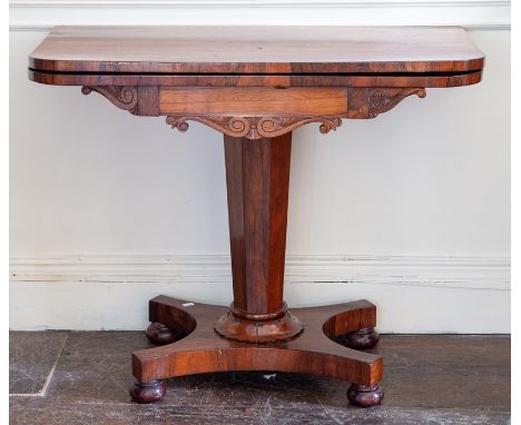 A William IV rosewood fold over card table, circa 1830, fold over top above carved frieze detail, raised on octagonal tapered