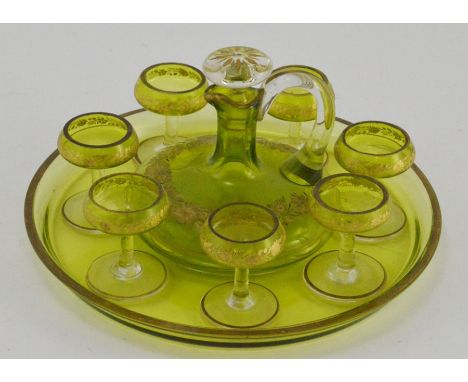A early 20th Century green glass liquer set, comprising a liquer decanter, seven glasses and circular tray (8)