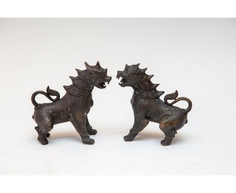A pair of oriental bronze rampant standing beasts, 20th Century, height 13cm (2)