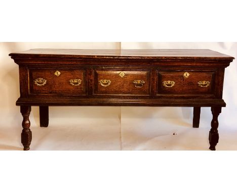 An early George III oak dresser base, circa 1760, rectangular top above moulded edge, fitted with three moulded panel drawers