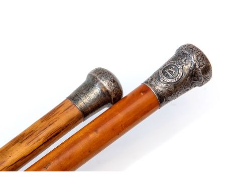 A malacca walking cane, the silver pommel with Royal Warwickshire Regt insignia, (hallmarks rubbed), length 90cm, and another