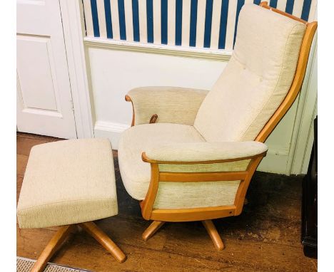 An Ercol elm reclining cream upholstered swivelling chair and matching footstool (2)