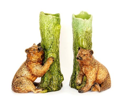 A pair of Bretby Art Pottery spill vases in the majolica style well-modelled as a bear standing next to a tree. No. 1248. Bot