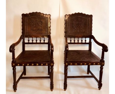 A pair mid 18th Century oak leather hall chairs, circa 1750, brass stud fitted leather back inlay of a heraldry type coats of