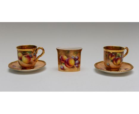 A pair of Royal Worcester painted fruit coffee cups and saucers, gilt interiors, the exteriors painted with plums and peaches