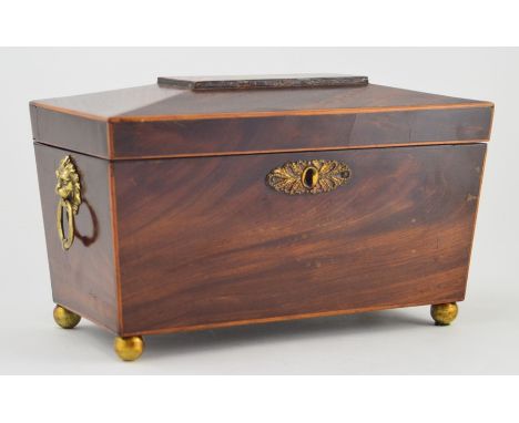 A George III mahogany tea caddy, circa 1800, sarcophagus form inlaid boxwood stringing, enclosing fitted interior with two li