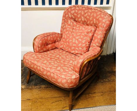 An Ercol solid beech three piece suite, each piece of stick back design, comprising three seater settee and two armchairs, (3