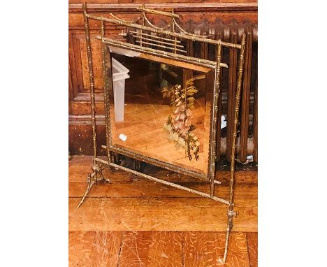 An Edwardian brass bamboo design firescreen, mirror glassed inlay with floral decoration. 77cm H x 56cm W