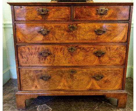 A George II figured walnut, double crossbanded and feather-banded chest of drawers, circa 1750, rectangular top above two sho
