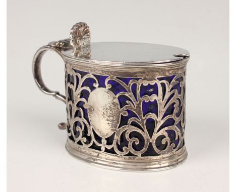 A late Victorian silver oval mustard, the tappit hinged lid with scallop shell thumbpiece above pierced scroll sides, London 