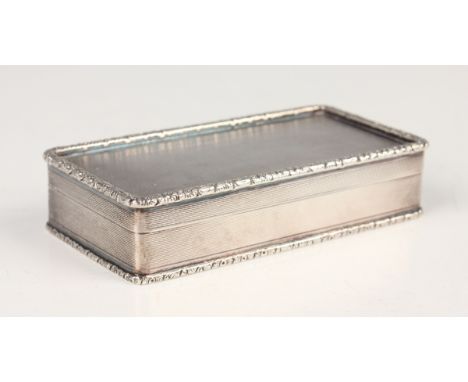 An Elizabeth II silver rectangular snuff box with engine turned decoration within raised cast flower and leaf borders, London