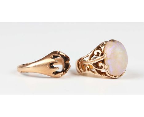 A gold ring, claw set with an oval opal, with pierced foliate shoulders, unmarked, weight 7.2g, ring size approx P, and a gil