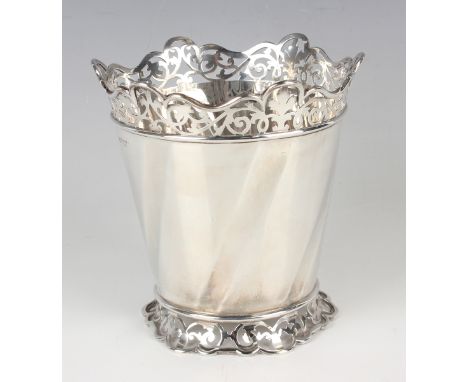 An Edwardian silver ice pail of spiral fluted tapering cylindrical form with pierced scroll rim and foot, London 1902 by Will