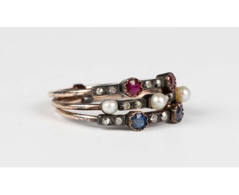 A gold and silver set, diamond, ruby, sapphire and seed pearl ring in a triple shank design, unmarked, weight 2.6g, ring size