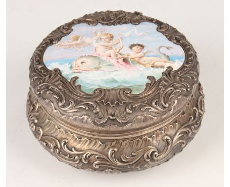 A 19th century French silver and enamelled circular box and cover, the cover with shaped enamelled panel painted with a class