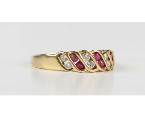 A gold, ruby and diamond ring, mounted with three pairs of circular cut diamonds alternating with three pairs of circular cut