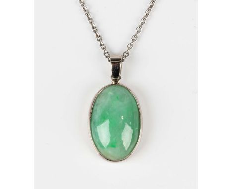A jade single stone pendant, collet set with an oval jade cabochon, unmarked, weight 3.4g, length 2.3cm, with a white gold ov