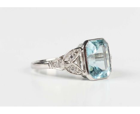 A platinum, aquamarine and diamond ring, collet set with the cut cornered rectangular step cut aquamarine between diamond set