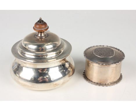 A George V silver squat circular tea caddy, the domed hinged lid with turned finial, London 1912 by Holland, Aldwinckle &amp;