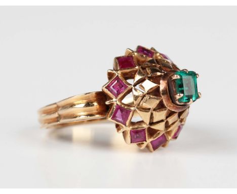 A gold, emerald and ruby ring, 20th century, probably Asian, mounted with a rectangular step cut emerald to the raised centre