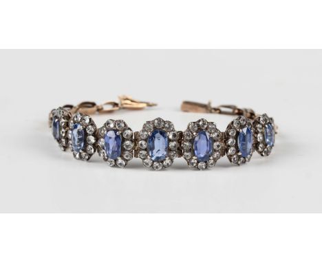 A gold and silver set, sapphire and colourless gem set bracelet, 1930s/40s, designed as a row of oval clusters graduating in 