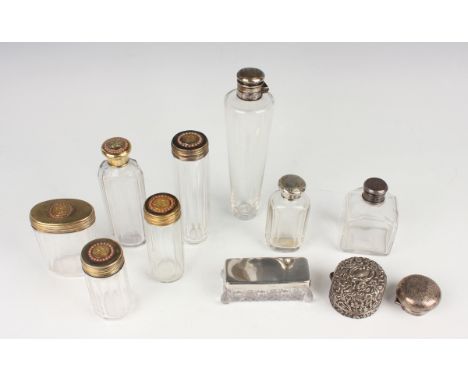 A set of five Victorian silver gilt and cut glass dressing table bottles and jars, each silver gilt cover monogram engraved f