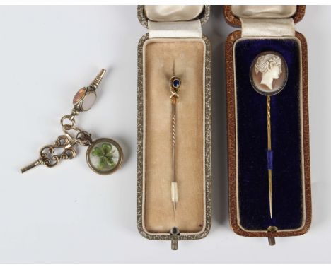 A gold topped stickpin, mounted with a cushion cut sapphire, a shell cameo stickpin, carved as a portrait of a lady, a Victor