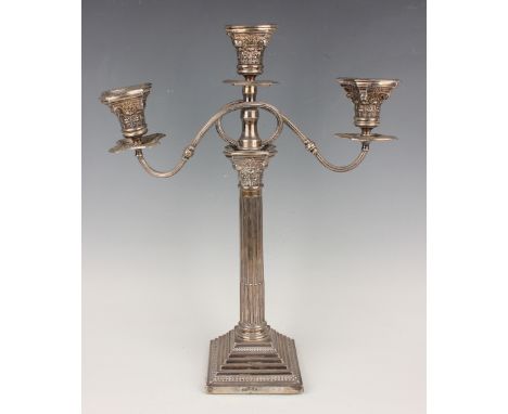 A George V silver Corinthian column three-light twin-scroll branch candelabrum, each urn shaped sconce with beaded nozzle abo