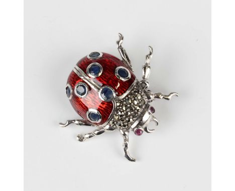 A silver, red enamelled, marcasite and sapphire brooch, designed as a ladybird with ruby set eyes, detailed '925', weight 8.2
