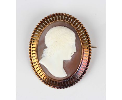 A Victorian gold mounted oval shell cameo brooch, 1860s/70s, carved as a portrait of a lady within a pierced and beaded surro