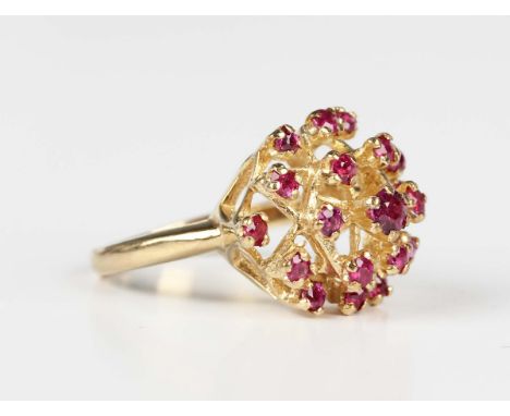A 9ct gold and ruby ring in a raised hexagonal openwork design, claw set with circular cut rubies, London 1972, weight 4.1g, 