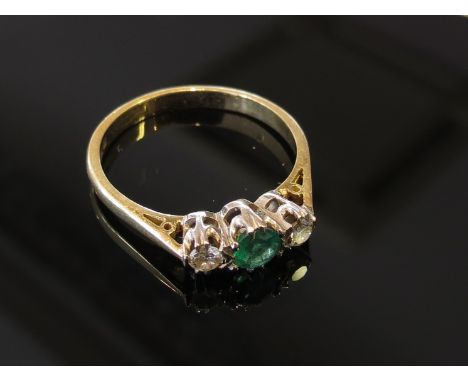 An 18ct gold emerald and diamond ring. Size N, 2.7g